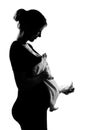 Pregnant woman portrait holding baby clothes Royalty Free Stock Photo