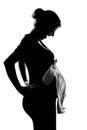 Pregnant woman portrait holding baby clothes Royalty Free Stock Photo