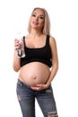 Pregnant woman posing with bottle of water. Close up. White background Royalty Free Stock Photo