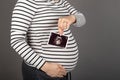 Pregnant woman posing on grey background