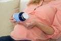 Pregnant Woman Pouring Pills In Hand From Bottle Royalty Free Stock Photo