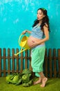 A pregnant woman pours cabbage. Everyone knows that children are met in cabbage. Waiting for the baby