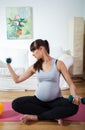 Pregnant woman practicing at home Royalty Free Stock Photo