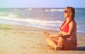 Pregnant woman practicing yoga at beach Royalty Free Stock Photo