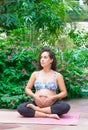Pregnant woman practicing yoga in a park. Healthy lifestyle. International yoga day