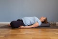 Pregnant woman practicing yoga in Reclined Butterfly exercise