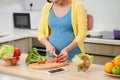 Pregnant woman preparing healthy food with fruit and vegetables. Close-up Royalty Free Stock Photo