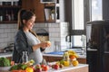 Pregnant woman preparing healthy food with lots of fruit and vegetables at home Royalty Free Stock Photo