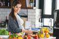 Pregnant woman preparing healthy food with lots of fruit and vegetables at home Royalty Free Stock Photo