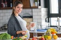 Pregnant woman preparing healthy food with lots of fruit and vegetables at home Royalty Free Stock Photo