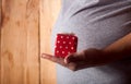 Pregnant woman with present for infant baby Royalty Free Stock Photo