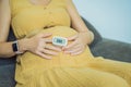 Pregnant woman with pulse oximeter on finger. Doctor measuring oxygen saturation level while visiting expectant mother Royalty Free Stock Photo