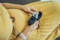 Pregnant woman with pulse oximeter on finger. Doctor measuring oxygen saturation level while visiting expectant mother Royalty Free Stock Photo