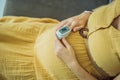 Pregnant woman with pulse oximeter on finger. Doctor measuring oxygen saturation level while visiting expectant mother Royalty Free Stock Photo