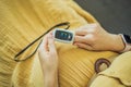 Pregnant woman with pulse oximeter on finger. Doctor measuring oxygen saturation level while visiting expectant mother Royalty Free Stock Photo