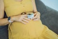 Pregnant woman with pulse oximeter on finger. Doctor measuring oxygen saturation level while visiting expectant mother Royalty Free Stock Photo