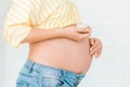 Pregnant woman is putting cream on her belly. Close up, isolated Royalty Free Stock Photo