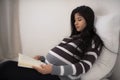 Pregnant woman reading a book Royalty Free Stock Photo