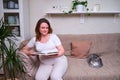 A pregnant woman reads a book about childbirth and children in the home interior, lifestyle Royalty Free Stock Photo