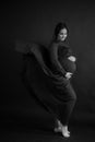 Pregnant woman in red flying dress holding her belly Royalty Free Stock Photo