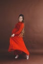 Pregnant woman in red flying dress holding her belly Royalty Free Stock Photo