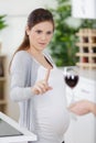 pregnant woman rejecting alcohol at home