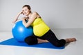 Pregnant woman relaxing against fitness ball