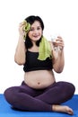 Pregnant woman relaxing after exercise Royalty Free Stock Photo