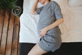 Pregnant woman relaxing resting on couch at home, expectant mother lying on sofa touching tummy Royalty Free Stock Photo