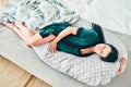 Pregnant woman relaxing or sleeping with belly support pillow in bed. Royalty Free Stock Photo