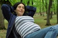 Pregnant woman relaxing on a tree Royalty Free Stock Photo