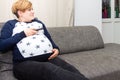 Pregnant Woman with a remote control Royalty Free Stock Photo