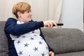 Pregnant Woman with a remote control Royalty Free Stock Photo