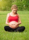 Pregnant woman is resting and relaxing on nature Royalty Free Stock Photo