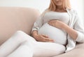 Pregnant woman resting on sofa at home Royalty Free Stock Photo