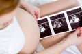 Pregnant woman reviewing baby ultrasound scan Royalty Free Stock Photo