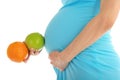 Pregnant woman's belly, apple and orange Royalty Free Stock Photo