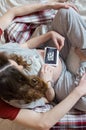 Pregnant woman`s belly and ultrasound in hands Royalty Free Stock Photo