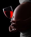 Pregnant woman's belly and wine Royalty Free Stock Photo