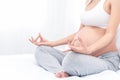 Pregnant woman`s hand close up. A pregnant young women exercising yoga at home preparing for the childbirth and expecting her