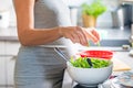 Pregnant woman`s hands washing and selecting salad in the kitchen Royalty Free Stock Photo