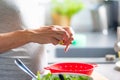 Pregnant woman`s hands washing and selecting salad in the kitchen Royalty Free Stock Photo