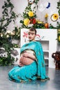 Pregnant woman in sari with henna tattoos