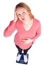 Pregnant woman on scales Royalty Free Stock Photo