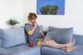 A pregnant woman in a semi-sitting position eating strawberries and using laptop Royalty Free Stock Photo