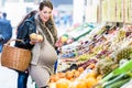 Pregnant Woman Shopping Groceries On Farmers Market