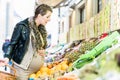 Pregnant woman shopping groceries on farmers market Royalty Free Stock Photo