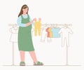 Pregnant woman is shopping for her new baby. Chooses children`s clothes in store Royalty Free Stock Photo