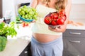Pregnant woman showing fruit and vegetables Royalty Free Stock Photo