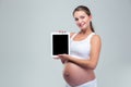 Pregnant woman showing tablet computer screen Royalty Free Stock Photo